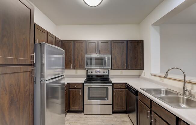a kitchen with stainless steel appliances and wooden cabinets