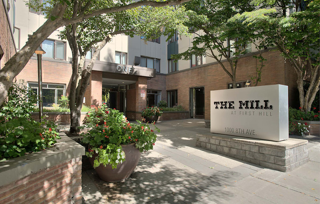 The Mill at First Hill is a modern building with a large entrance and a sign on the front.
