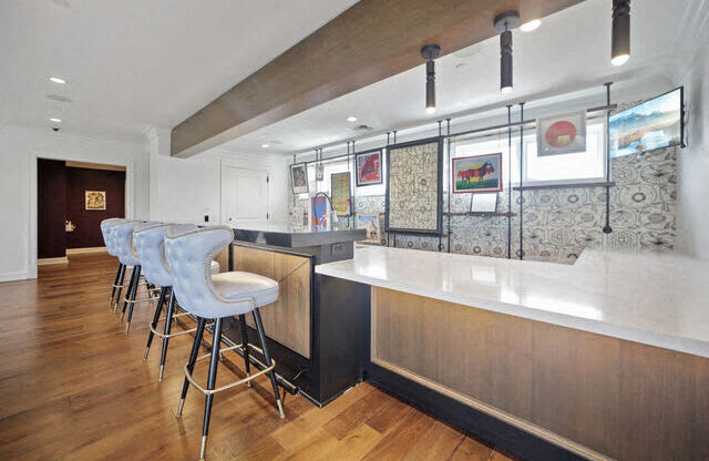 a kitchen with a bar and stools
