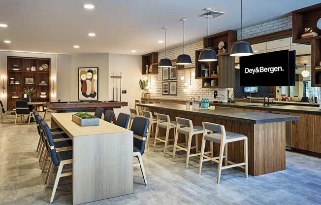 a kitchen with a large island and a bar with chairs at Dey & Bergen, Harrison, NJ