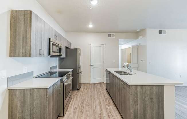 a renovated kitchen with stainless steel appliances and white counter tops