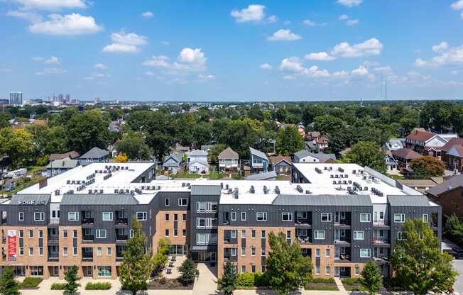 A large apartment complex with a parking lot in front.