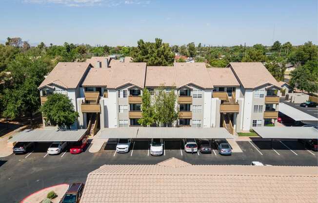 an aerial view of an apartment complex with a parking lot