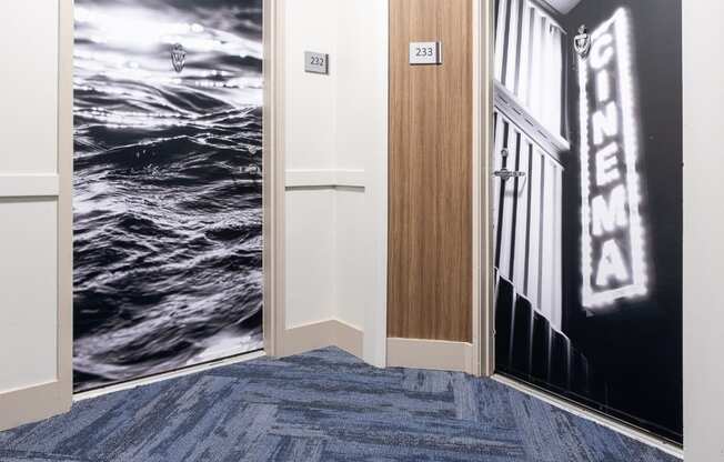 a carpeted hallway with two doors