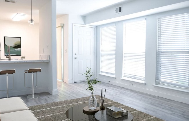 a living room with white walls and white windows with white shutters