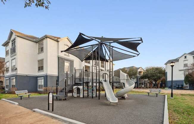 Community playground with sun cover at Park West Apartments in Houston, Texas