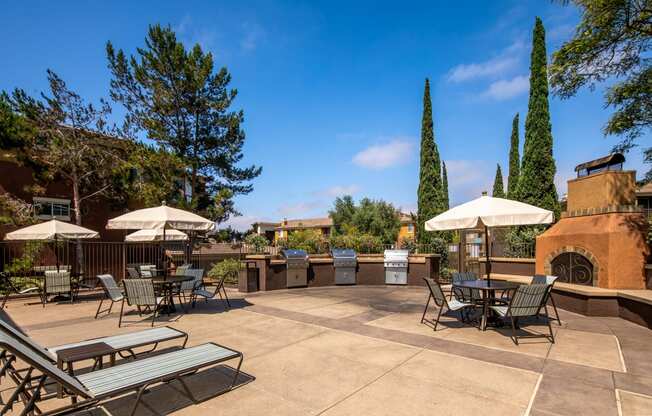 a patio with tables and chairs and umbrellas