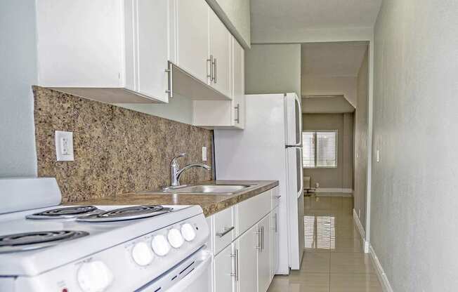 White appliances in select units - Helios Apartments Miami Beach