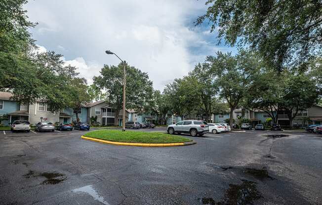 a city street with cars parked in front of houses