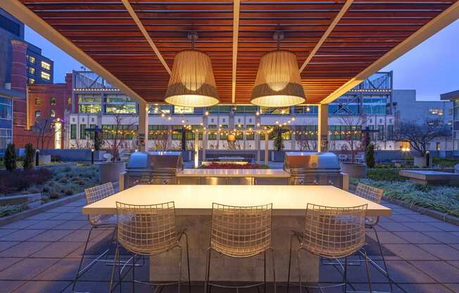 a dining area with a table and chairs under a roof