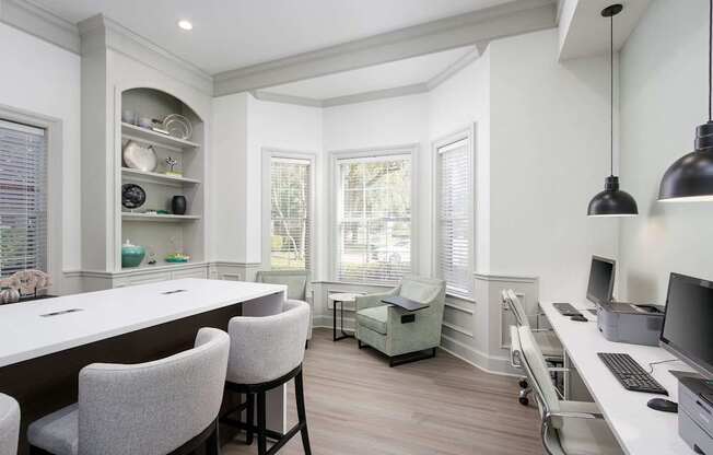 A well-lit, modern kitchen with a dining area and a home office.