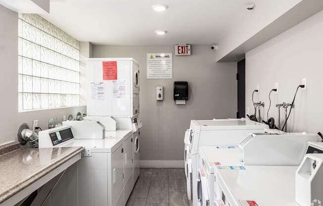 A laundry room with washers and dryers.