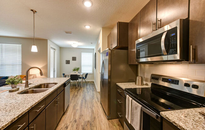 a kitchen with a stove top oven next to a sink  at Fusion, Florida, 32256