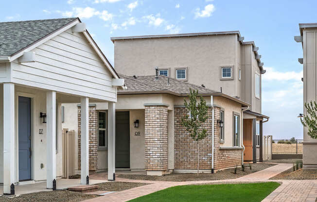 A row of houses with a blue sky in the background.