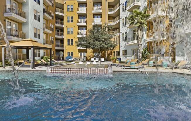 a large pool with a building in the background