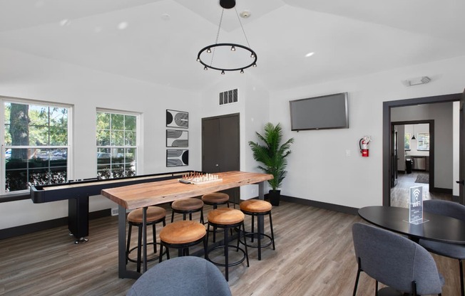 a living room with a bar and a table with stools