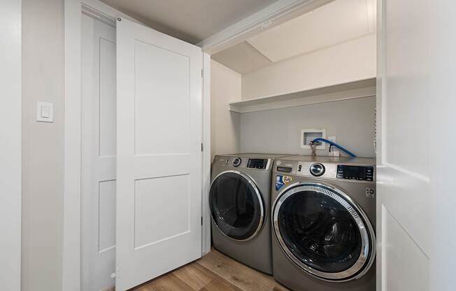 a washer and dryer in a laundry room with white doors