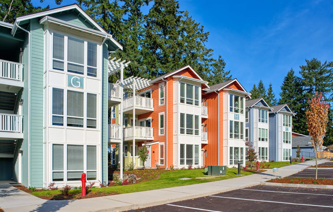 a row of colorful town houses on a sidewalk at Woodcreek, Poulsbo, WA