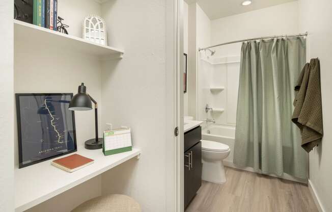 a bathroom with a white toilet next to a green shower curtain