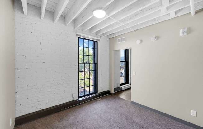 A room with a white brick wall and a window.