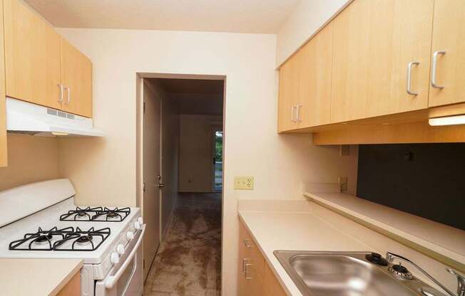 Kitchen with Maple Cabinetry and a breakfast bar at Irish Hills Apartments, South Bend, Indiana