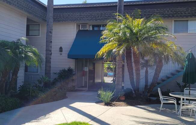 Patio in courtyard area with enterance and mailboxes in the background at La Mesa Village Apartments in La Mesa, California.