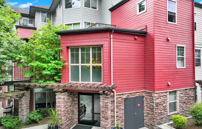 A red building with a black door and windows.
