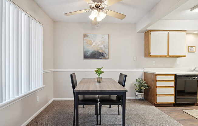 a dining room with a table and a ceiling fan