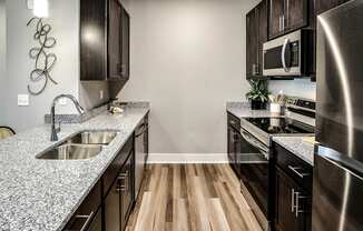 Kitchen with stainless steel appliances at Sterling Prairie Trail North in Ankeny, IA