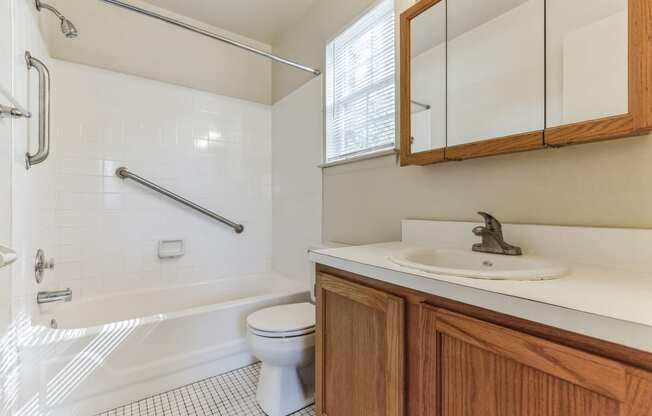 an empty bathroom with a sink toilet and bath tub