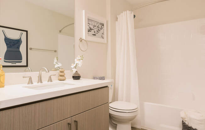 A bathroom with a white toilet and a white sink.