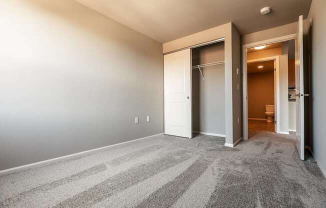 A room with a striped carpet and a white door.