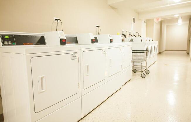 Laundry Center with Machines Next to Folding Counter at The Greenway at Carol Stream, Carol Stream