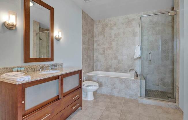 A bathroom with a toilet, sink, and shower.