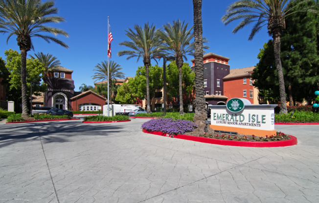 The image shows a sign for Emerald Isle in front of some palm trees.