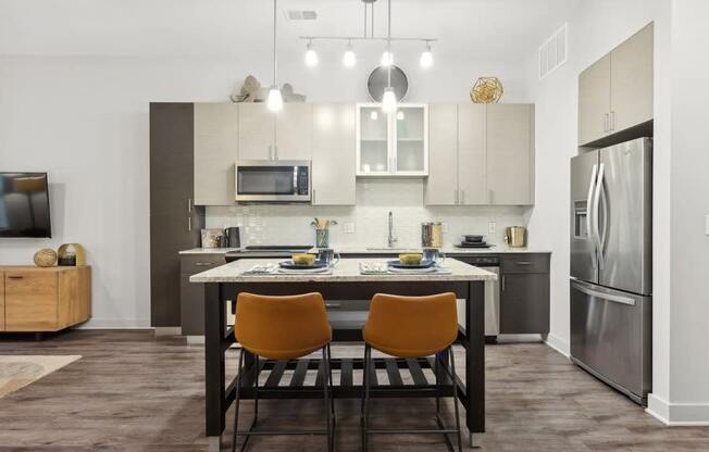 a kitchen and dining room with a table and chairs