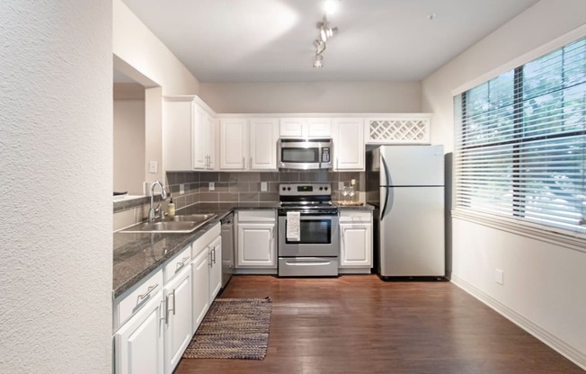 This is a photo of the kitchen of the 1661 square foot 3 bedroom, 3 and a half bath floor plan at The Brownstones Townhome Apartments in Dallas, TX.