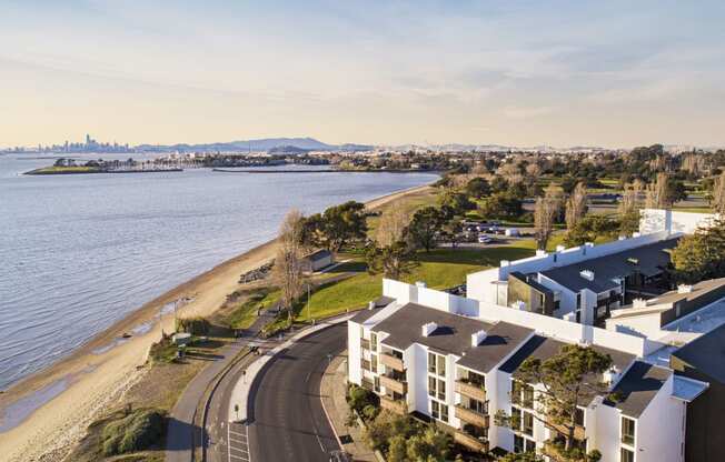 an aerial view of an apartment complex next to the water