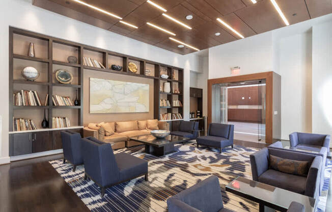 a lobby with couches and chairs and a large map on the wall at The Millennium, Arlington, 22202