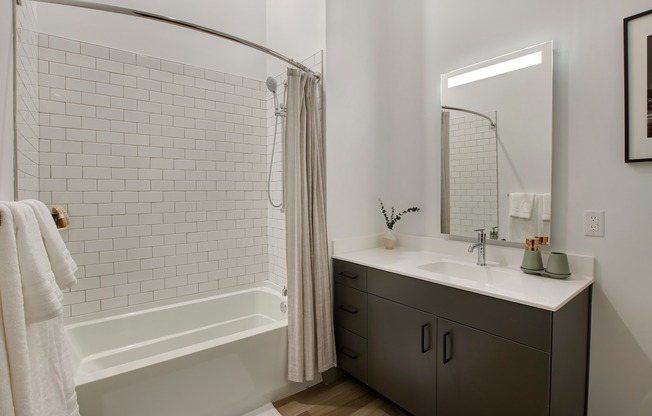 Serene bathrooms with quartz countertops and edge-lit mirrors