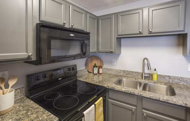 a kitchen with stainless steel appliances and granite counter tops