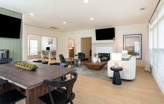 a living room with a fireplace and a dining table
