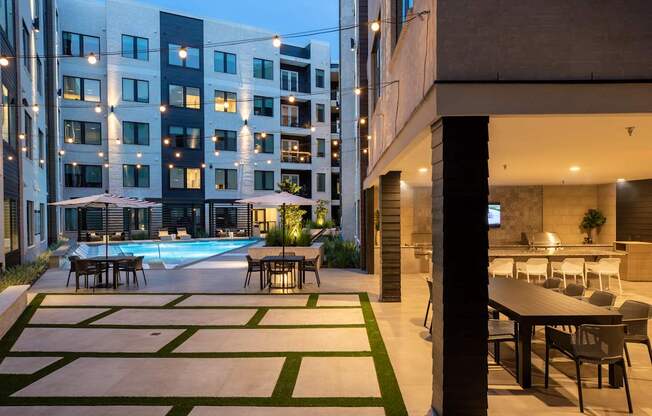A modern building with a pool and a dining area.