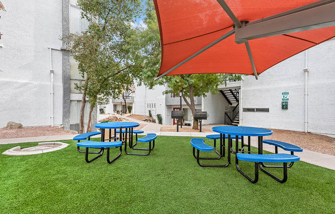 Outdoor Pic Nic Area with Tables and Orange Canopy at Crystal Creek Apartments in Phoenix, AZ.