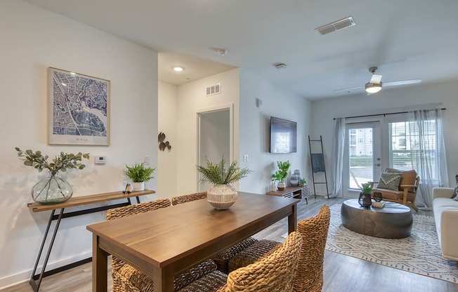 A dining room with a wooden table and chairs.