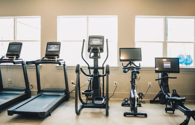 a row of exercise equipment in a gym
