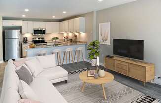 A modern living room with a white sofa, wooden coffee table, and a television.