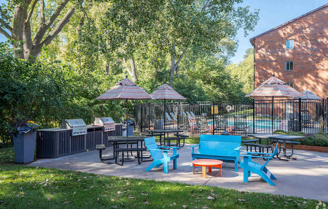 a patio with tables and chairs and umbrellas