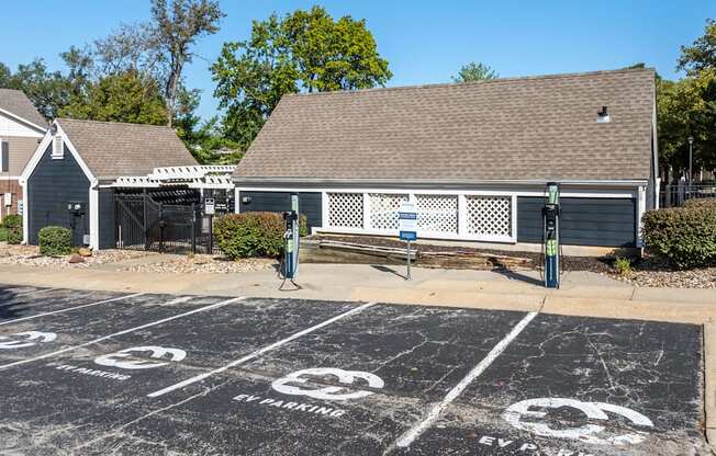 A parking lot with a sign that says "EV PARKING" on the pavement.