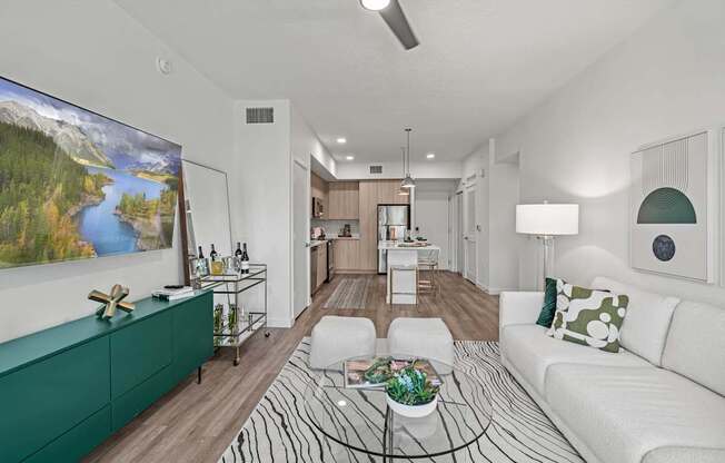 A living room with a white couch and a green cabinet.